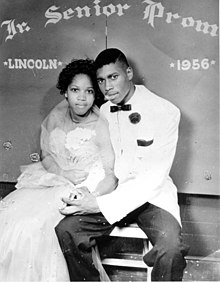 For females, late adolescence is a crucial period in determining their reproductive success. Portrait of African American couple at Lincoln High School senior prom (6846385789).jpg