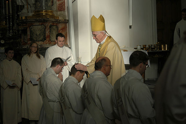 Laying on of hands during a Catholic priestly ordination in Germany