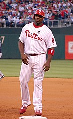 Ryan Howard wearing the current Phillies' white home uniform with red pinstripes and the Harry Kalas patch in 2009