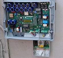 Internal view of a solar inverter. Note the many large capacitors (blue cylinders), used to store energy briefly and improve the output waveform. Sunny Boy 3000.jpg