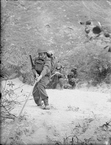 Soldiers of 4th Bn, Wiltshire Regiment, climbing the sheer face of a chalk quarry during 'toughening up' training at Leeds, Kent, 18 September 1941.