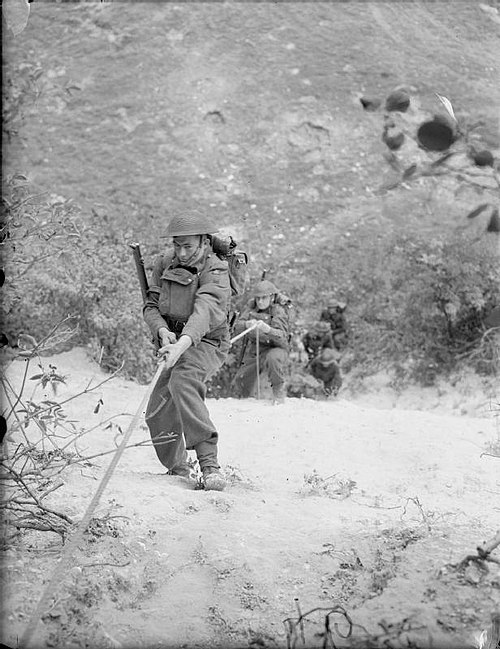 Soldiers of 4th Bn, Wiltshire Regiment, climbing the sheer face of a chalk quarry during 'toughening up' training at Leeds, Kent, 18 September 1941.