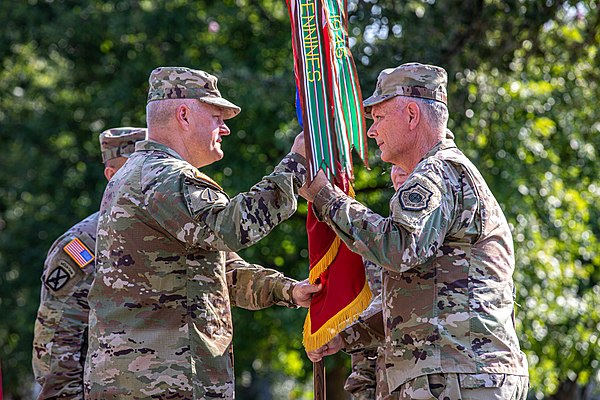 Gen. Glen D. VanHerck, right, Commander, North American Aerospace Defense Command and United States Northern Command, passes the U.S. Army North color