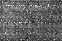 A section of the 1886VE10 microcontroller die by an electron microprobe. The small bright cylinders are tungsten vias left over from metalization etching. X-ray spectroscopy can be used to determine the composition of the vias. 1886VE10-SEM-HD.jpg