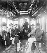 Passengers aboard early electric tram (1897)