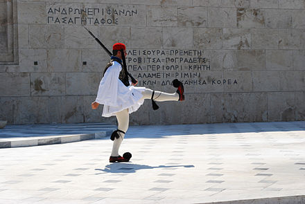 The Tomb of the Unknown Soldier in Athens. The inscription "ΡΙΜΙΝΙ" can be seen in the stone carved text right above the guard's foot.