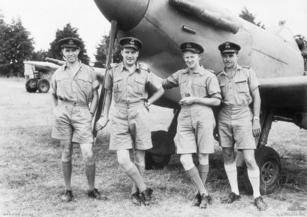 Four No. 54 Squadron RAF pilots standing in front of a Spitfire at Richmond