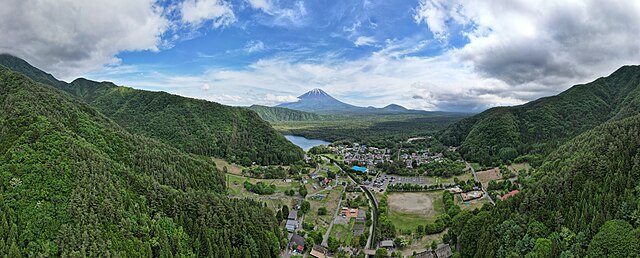Aerial panorama of Mount Fuji with Saiko Iyashi-no-Sato Nenba in the foreground, June 2023