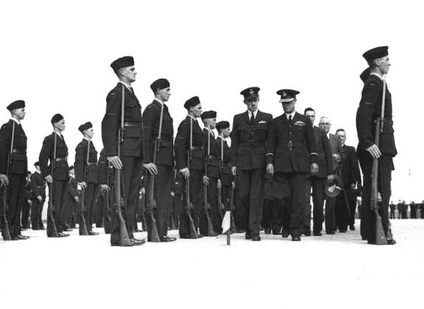 Air Commodore De La Rue (braided cap), inaugural AOC Western Area, inspecting pilot trainees, c. 1941