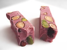 A ruby chocolate bar containing caramelised almonds and pistachios Chocolat Ruby.jpg