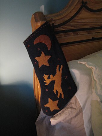 A Christmas stocking hung on a bedpost.