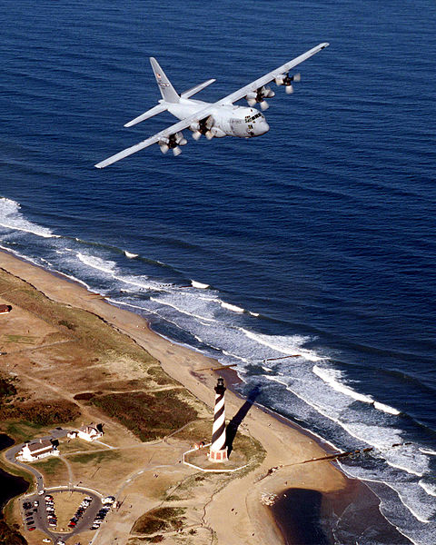A 43rd Operations Group C-130 flies over the Cape Hatteras lighthouse along the North Carolina coast