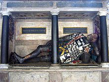 Monument and semi-recumbent effigy in Ely Cathedral of Robert Steward (1526/30-1570), another nephew, of the Dean who displays the "Steward Augmentation" (Argent, a lion rampant gules debruised by a bend raguly or) said to have been awarded to his ancestor Sir Alexander Steward "The Fierce" (a grandson of Alexander Stewart, 4th High Steward of Scotland (died 1283)) by the French King Charles VI (1368-1422) Elytomb.jpg