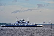 The Fort Fisher Ferry crosses the Cape Fear River returning from Southport.The cranes in the background are part of the US Army's Military Ocean Terminal Sunny Point (MOTSU) in Brunswick County. FFFerryMOTSU.jpg