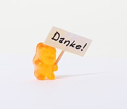 A gummi bear holding a sign that says "Thank you"