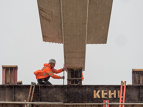 An engineer controls the position of a bridge element during rainy weather.