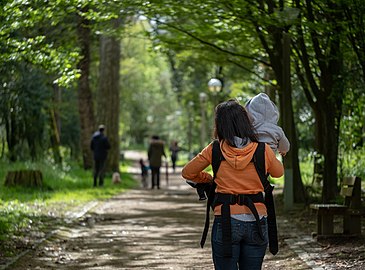 Jules putting Gabriel into a baby carrier, Quinta das Conchas park, Lisbon, Portugal