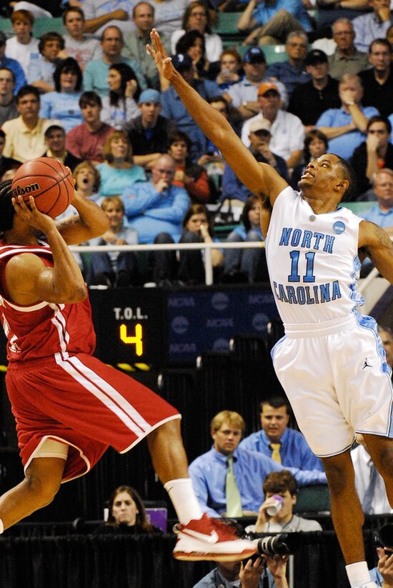 Drew (right) defending in 2009