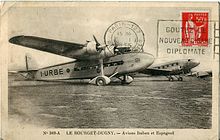 Paris-Le Bourget Airport in 1935. I-URBE (in the foreground) is an S.74; the other aircraft is a Douglas DC-2 airliner operated by the Spanish airline LAPE (Lineas Aereas Postales Espanolas). Le Bourget-DUGNY Avions.JPG