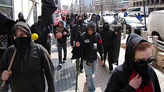 Christine Robinson identifies the black bloc tactic as a component of security culture. March on Crystal City, black bloc near World Bank.jpg
