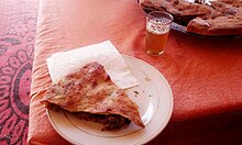 Medfouna or Berber Pizza at a local restaurant near Merzouga, Errachidia, Morocco.jpg