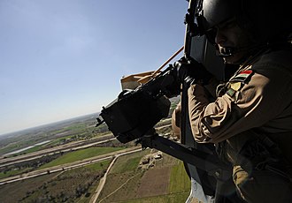 An Iraqi Army Aviation Command aerial gunner prepares to test fire his M240 machine gun, 2011 Mi-171 advisor pilots provide training - day or night DVIDS379824.jpg