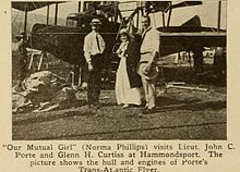 A cutting from Moving Picture World 25 July 1914: Glen Curtiss, actress Norma Phillips (Our Mutual Girl)[24] and Porte with his characteristic straw hat in front of the Trans-Atlantic Flyer.[25]