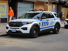 A Ford Police Interceptor Utility marked police car in the United States New York City Police 122nd Precinct Ford PIU (Left front).jpg