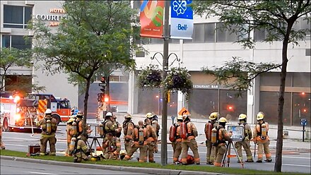 Firefighters in Montreal in full turnout gear during a fire