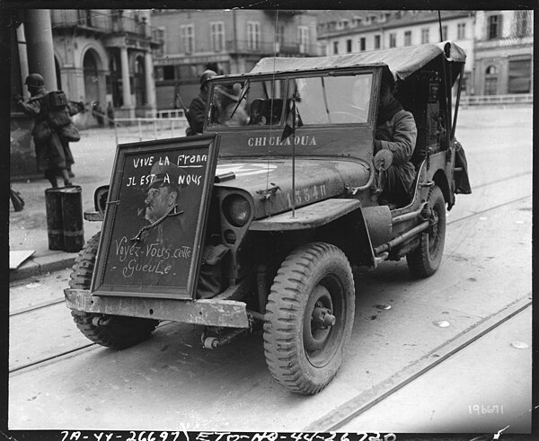 Members of the 1st French Army, in the Mulhouse area, France, decorated this jeep with a captured picture of Hitler: 21 November 1944