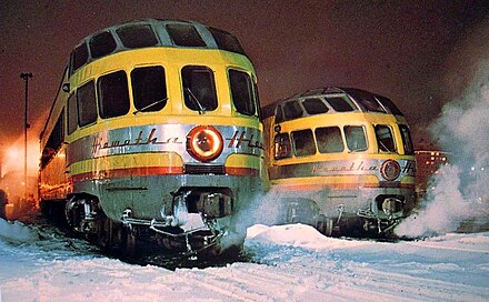 Two Skytop Lounges in their fourth Milwaukee Road paint scheme, matching Union Pacific colors. These cars were part of the Twin Cities Hiawatha equipment pool.