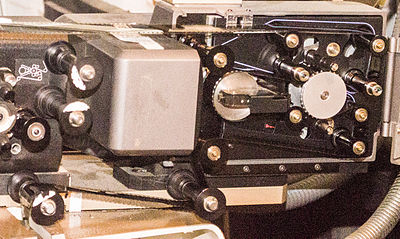 A Sony DFP-R2000 SDDS reader mounted on a Norelco AAII projector, with film threaded.