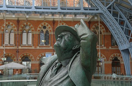 Statue of poet Sir John Betjeman looking up at architecture of London St. Pancras station. You should too! Major British stations are often impressive works of Victorian architecture.