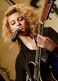 Kelly performing in 2014 Tori Kelly at NAMM 1 24 2014 -5 (12231930684).jpg