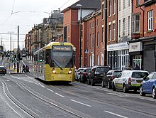 A Metrolink tram running through Union Street, on the Oldham town centre line opened in January 2014. Tram on Union Street, Oldham, looking west, geograph-3808797-by-Alan-Murray-Rust.jpg
