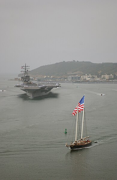 File:USS Ronald Reagan (CVN 76), left, is led by "Old Glory" as it eases through San Diego Bay to its home on North Island Naval Air Station in California July 6, 2006, after its maiden deployment 060706-N-HX866-001.jpg