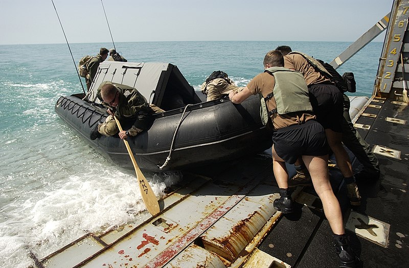 File:US Navy 030317-N-5319A-011 Members of the Deep-Shallow Water Mark 7 crew from Commander Task Unit (CTU-55.4.3) push their dive boat off the well deck of the USS Gunston Hall (LSD 44).jpg