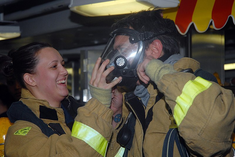 File:US Navy 071205-N-6516T-182 Damage Controlman Fireman Dalena Powell helps TV and film star Johnny Knoxville don fire fighting equipment on the aft mess deck aboard the nuclear-powered aircraft carrier USS Nimitz (CVN 68).jpg