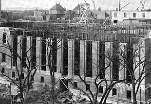 The stacks framework (visible within unfinished walls in this December 1913 view) of Harvard's Harry Elkins Widener Memorial Library supports the roof and topmost level of offices and special collections as well as shelves holding 3 million volumes. WidenerLibraryUnderConstruction 1913Dec4 cropped.jpg