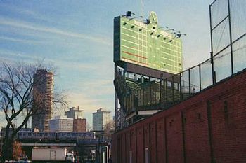The north exterior of Wrigley Field, with manual scoreboard visible, as it appears during the offseason. This picture was taken prior to the outfield bleacher expansion, which brought the bleachers over the sidewalk.