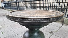 Inscription of John Barker on the second oldest "Nail" in front of The Corn Exchange in Bristol 16th- oder 17th-century brass pillar II in Corn Street, Bristol, second oldest nail there, side view with inscription of John Barker (Bristol MP) who died 1636.jpg