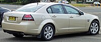 Rear-three-quarters view of a gold-coloured sedan