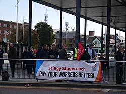 A close-up of the banner and some strikers at the Stagecoach in Hull-Unite picket line at Hull Paragon Interchange