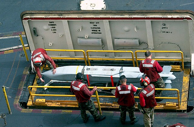 AGM-154 being brought to the flight deck of an aircraft carrier