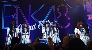 Members Jennis, Namneung, Maysa, Namhom, Kaimook, and Miori, clad in the first single outfit, perform at The Mall Bang Kapi in Bangkok on 23 July 2017. BNK48 - Roadshow - 2017-07-23 (003b).jpg