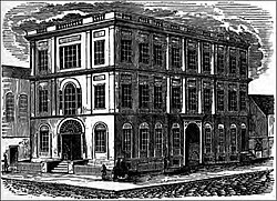 The old "Assembly Rooms" of the former Baltimore Dancing Assembly, built 1797, third floor added 1835. First major school-owned structure of "The High School" (founded 1839), purchased 1843, later called the "Male High School" briefly after 1844, renamed the "Central High School of Baltimore", (later becoming The Baltimore City College in 1866). The building located at the northeast corner of Holliday and East Fayette Streets, burned in November 1873, in a fire that spread from the adjacent famous Holliday Street Theater. It is now the site of the War Memorial Plaza (constructed 1917-1925) between the later Baltimore City Hall of 1867-75, to the west and the War Memorial Hall of 1925, to the east City College2.jpg