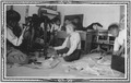 Boys paint furniture in classroom while others watch - NARA - 285539.tif