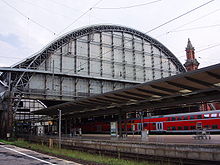 Blick vom nördlichsten Bahnsteig auf die Westeinfahrt der Gleishalle und einen Eckturm des Empfangsgebäudes