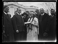 1923 photo of Calvin Coolidge with a Native American group at the White House Calvin Coolidge with Native American group at White House, Washington, D.C. LCCN2016892933.jpg