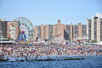 Coney Island beach, amusement parks, and high rises as seen from the pier in June 2016